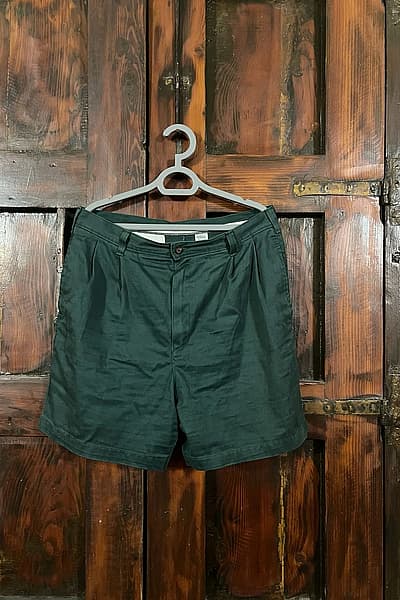 Dark green pleated tailored shorts by St. Michael Marks & Spencer — pre-loved on Thrifted.mt