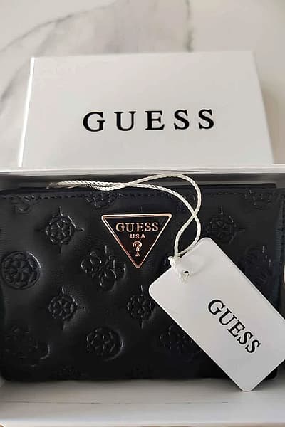 Guess Logo Embossed Wallet by GUESS — pre-loved on Thrifted.mt