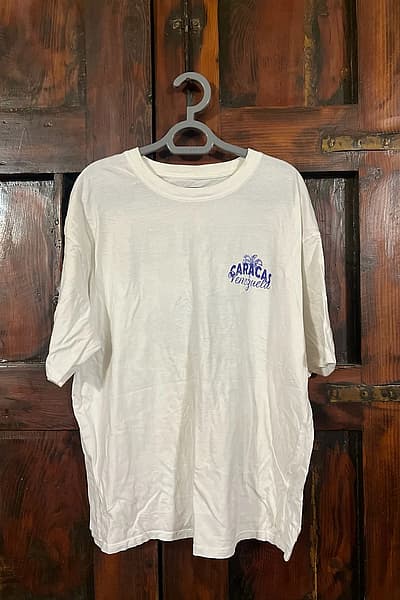 White Caracas Venezuela Graphic T-Shirt by Kiabi — pre-loved on Thrifted.mt