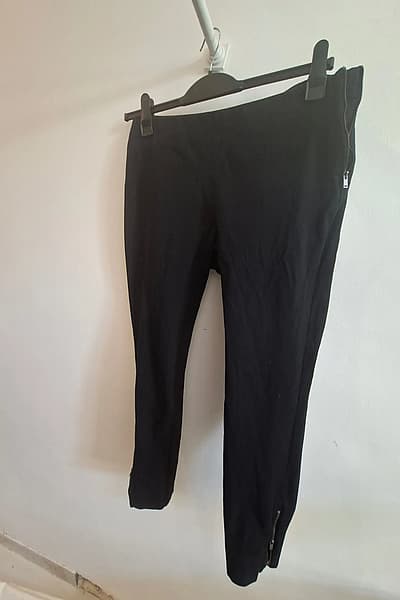 Black stretch ankle zip trousers by Yessica — pre-loved on Thrifted.mt