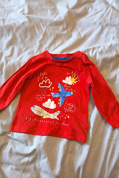 Red aeroplane graphic long-sleeve top by Mothercare — pre-loved on Thrifted.mt