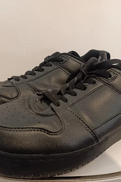 Classic black low-top trainers — pre-loved on Thrifted.mt