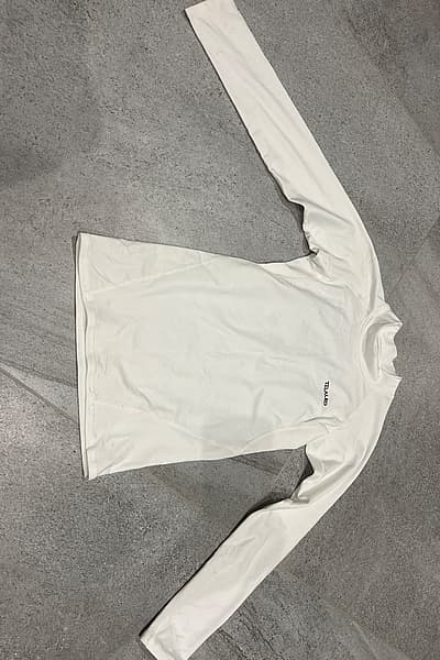 White long sleeve base layer by Telaleo — pre-loved on Thrifted.mt